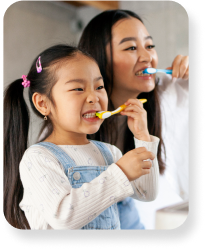 A mother and daughter brushing their teeth