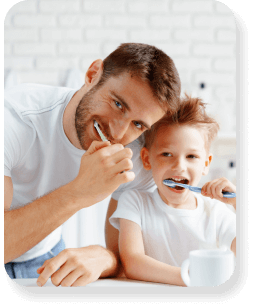 A father and son having fun whilst brushing their teeth.