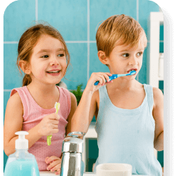 A brother and sister about to brush their teeth.